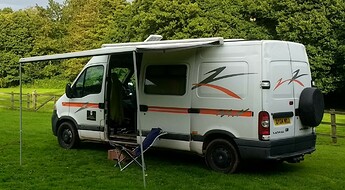 VAN IN FIELD LOWOOD. AWNING OUT
