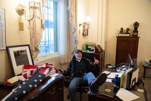 A Trump supporter sits in Nancy Pelosi’s office amid the violent siege of the Capitol.